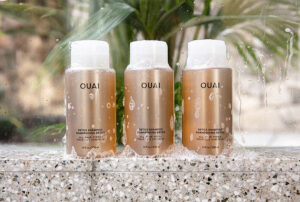 a promotional photo from The Ouai, of three of their Detox Shampoos with Shampoo Suds on them