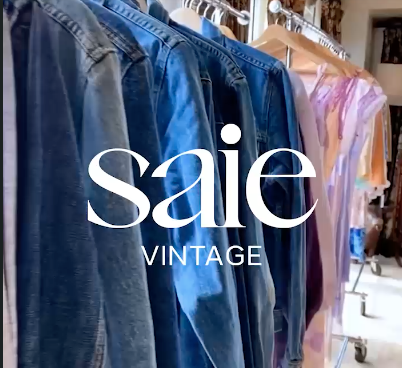 a shot from Saie's website, of some of their vintage merch collection, including many denim jackets, and lilac toned dresses