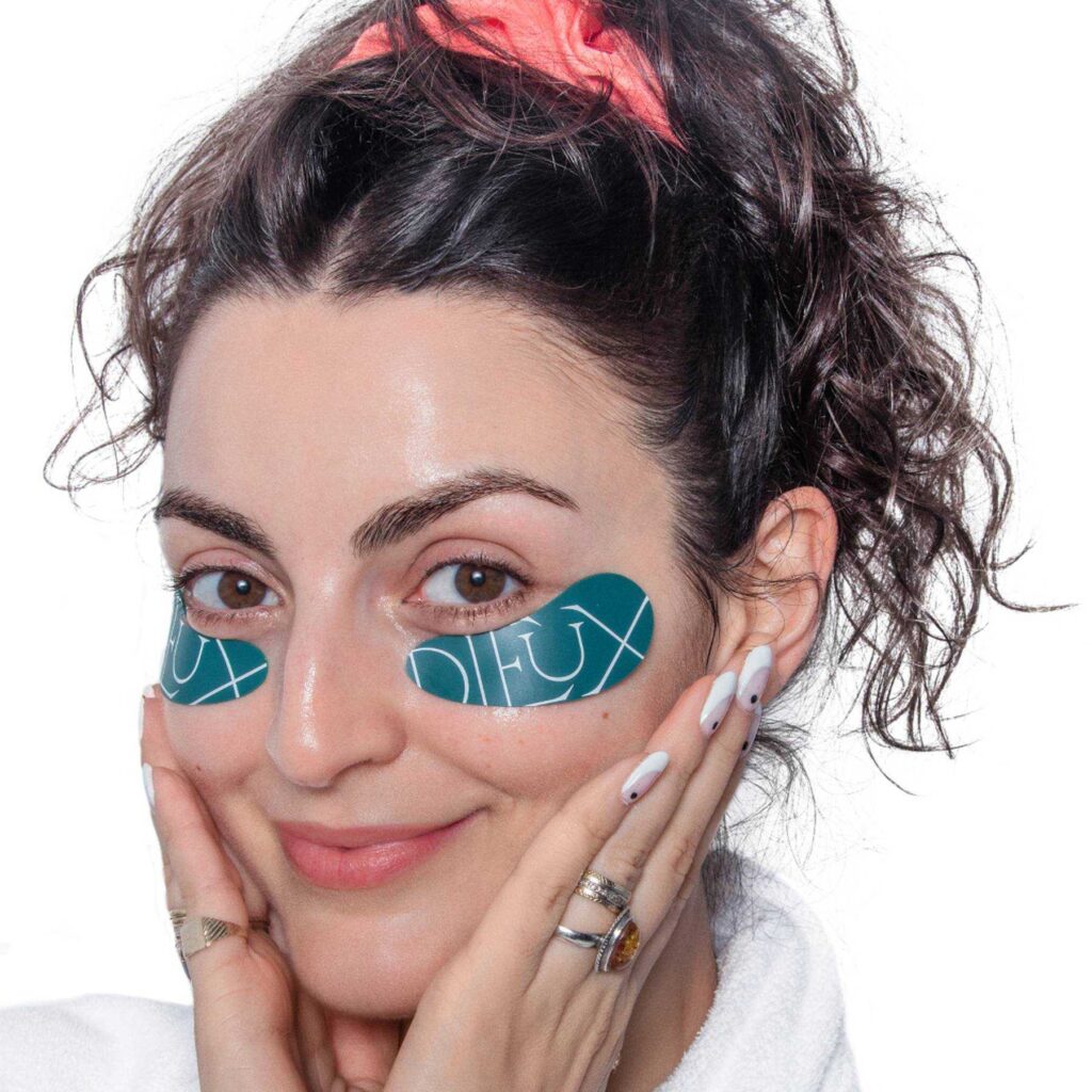 A photo of Charlotte Palermino with her hair up and wearing the dieux skin eye masks