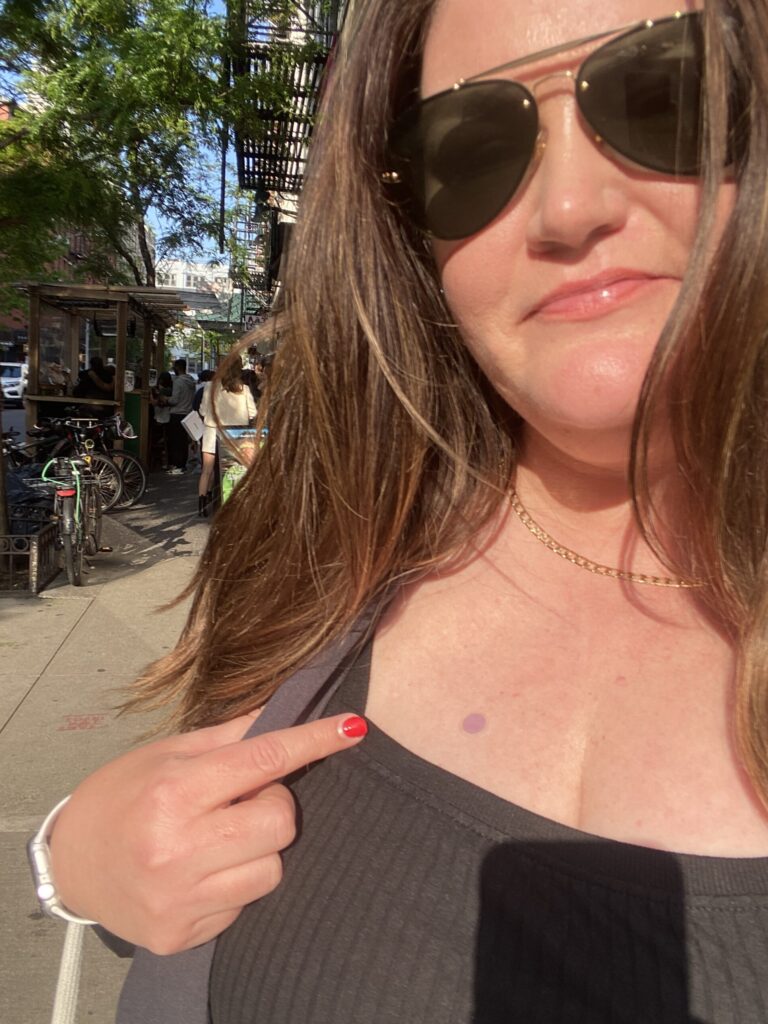 Jill using her Spot my UV Sticker - a sticker that indicates when it is time to reapply SPF