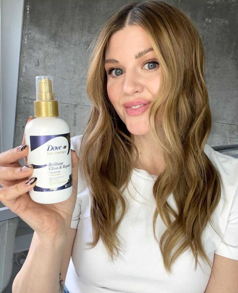 Kirsten Kontz posing with one of the new Dove Hair Therapy Products