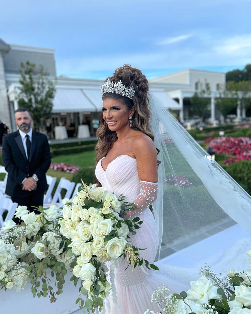 A photo of Teresa Giudice on her wedding day - in the photo she is wearing a white wedding dress and has extremely tall hair