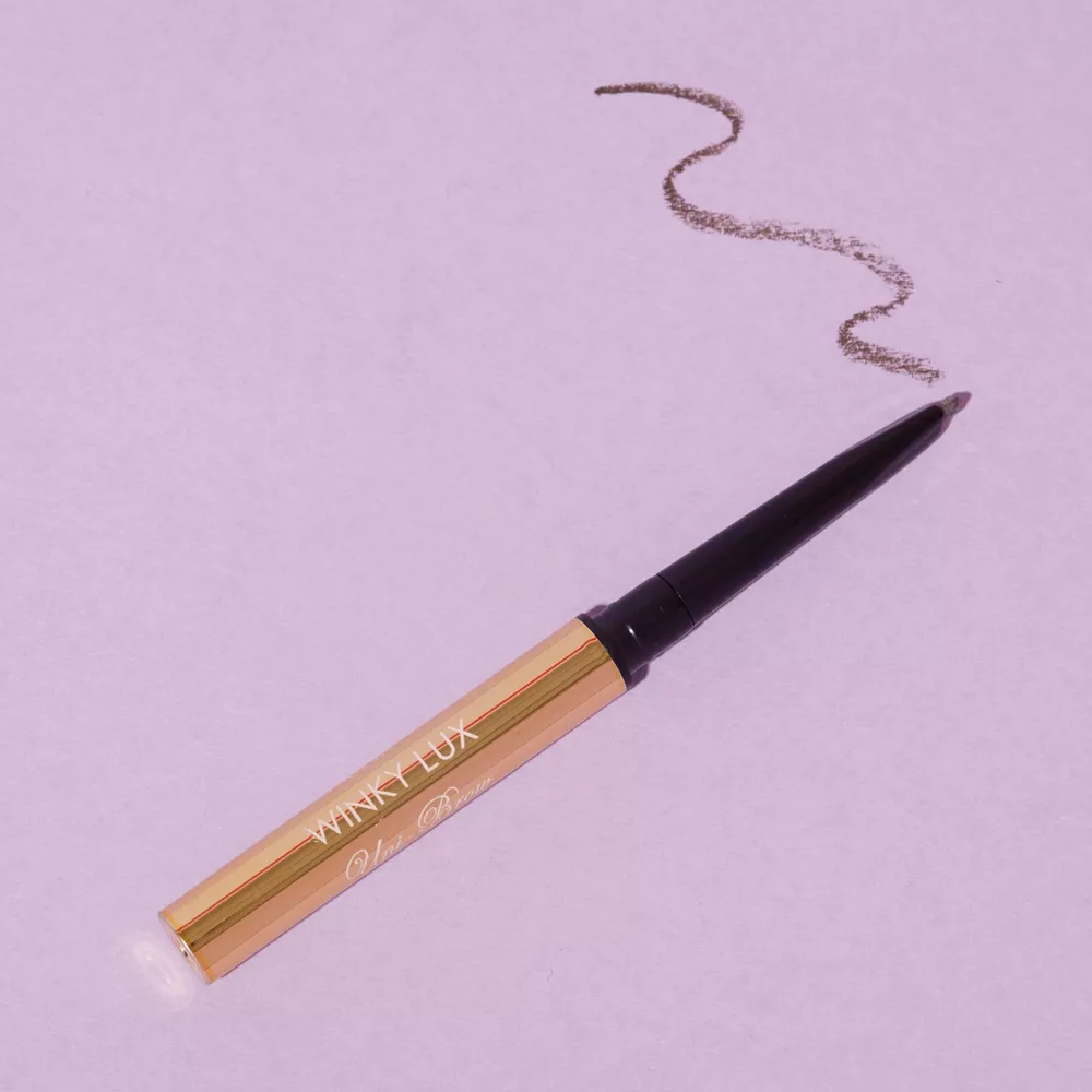 A promotional photo of the Winky Lux mini eyebrow pencil